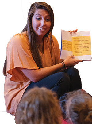 Photo of a student teacher reading to a class.