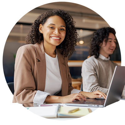 Woman at a desk, looking at the camera.